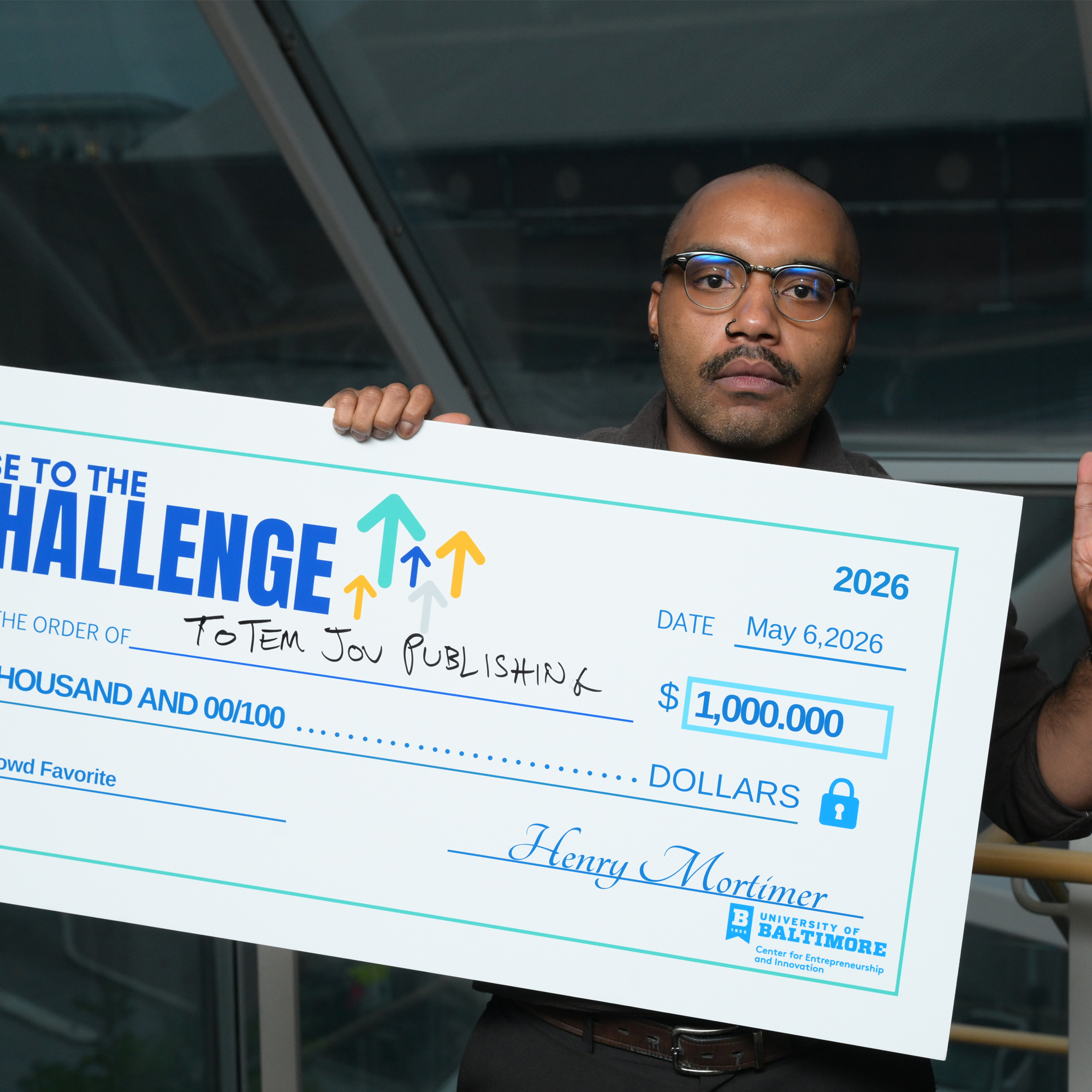 John Butler poses with the Rise to the Challenge oversized check for Crowd Favorite award