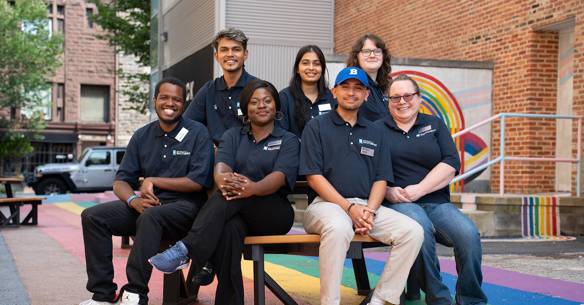 Orientation leaders sit on a table in Inclusion Alley