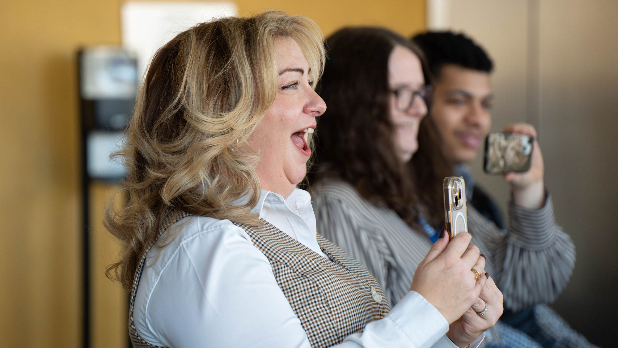 Dena Allen-Few, U.S. Army Veteran and Coordinator for The Bob Parsons Veteran Center laughing at a joke made by Bria Howard during the 2025 Veterans Day Ceremony.